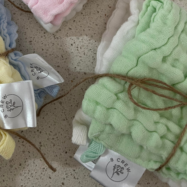 Bundled up face cloths in mint green, white, lemon and blue