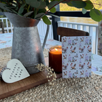 Load image into Gallery viewer, Nabiac Friends farm animal card displayed on table with candle, plant and water background.
