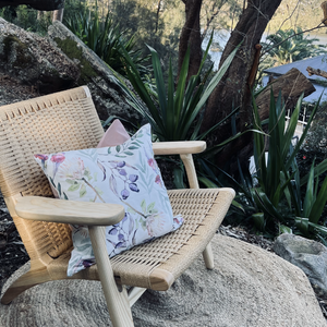 Cushion on garden chair with native flora design.