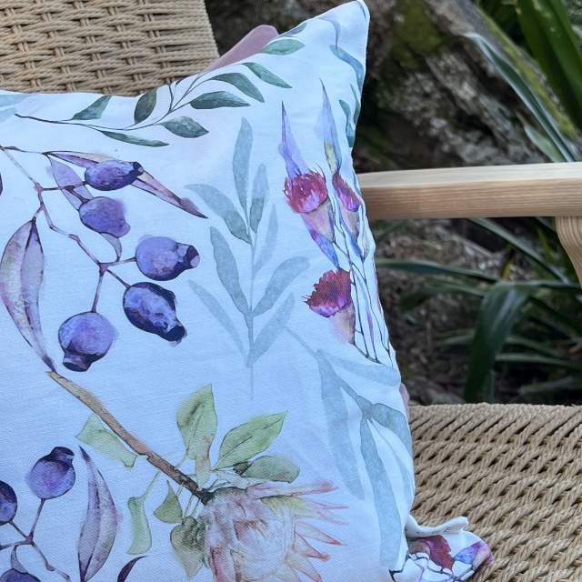 Close up of cushion with insert and Australian native flora design.