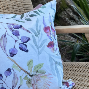 Close up of cushion with insert and Australian native flora design.