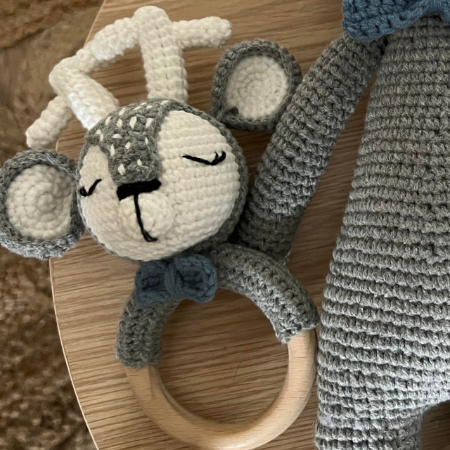 Hand knitted baby rattle in reindeer shape grey with white and blue trim