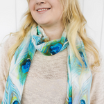 Load image into Gallery viewer, Smiling lady with blond hair wearing peacock print scarf around neck
