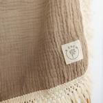 Load image into Gallery viewer, 8crew logo on taupe fringed baby swaddle
